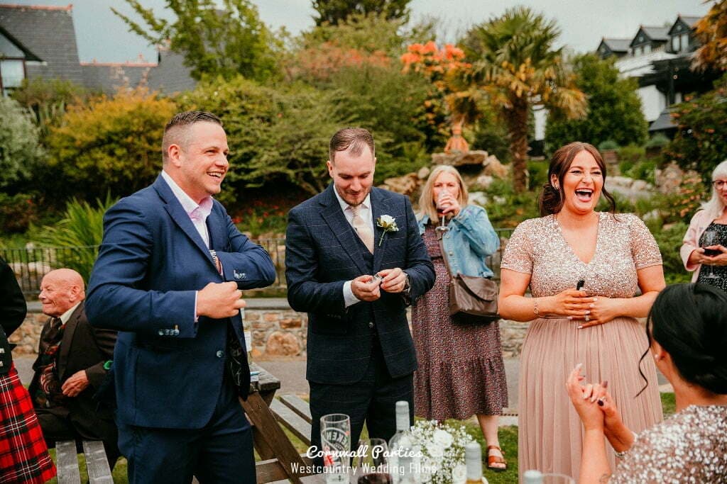 Lewis performing close-up magic during a stylish wedding reception.