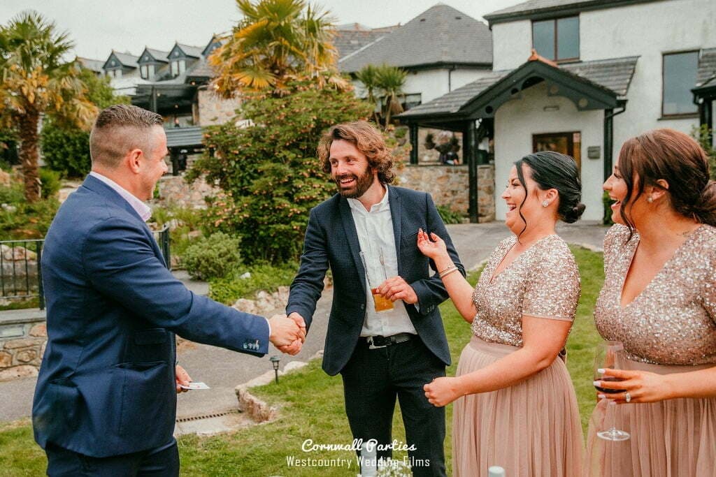 Couple and guests smiling during a wedding magic performance.