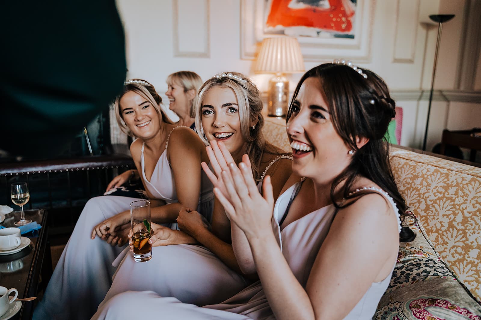 A group of wedding guests reacting to Lewis Belcher performing close-up magic.