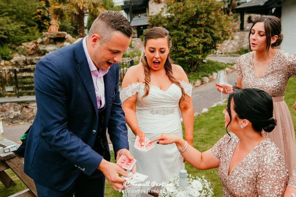 Wedding guests reacting together during a stylish drinks reception performance.