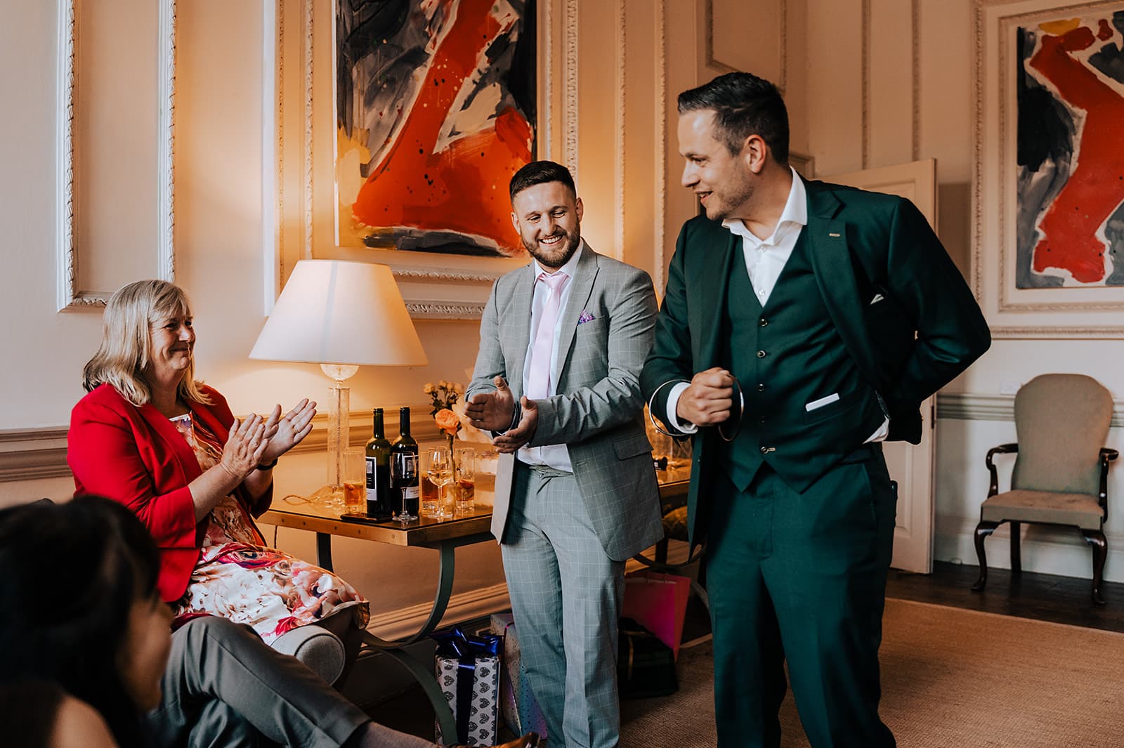 Lewis Belcher entertaining a wedding group in an elegant reception room.