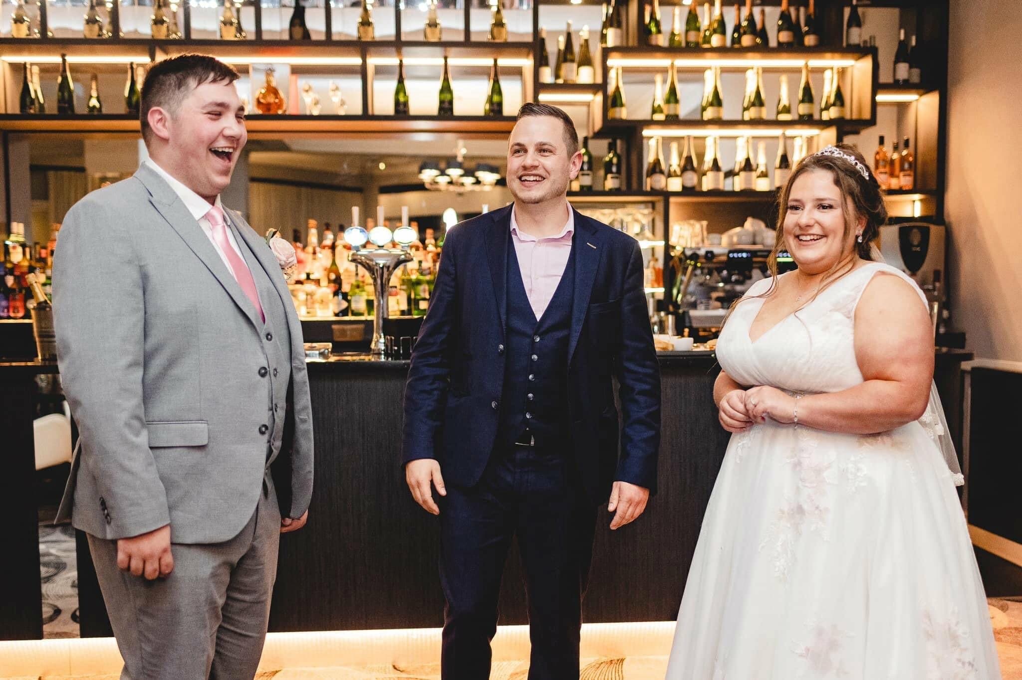 Lewis Belcher entertaining a couple during a reception.